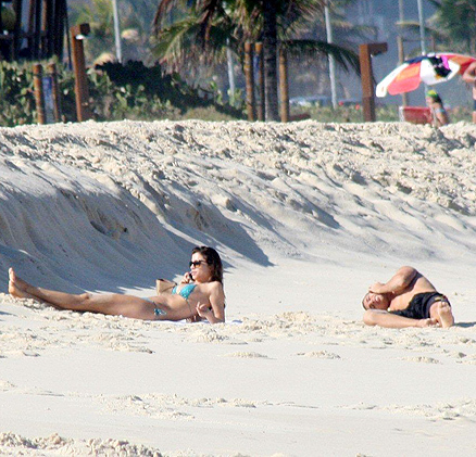 Os dois deitaram na areia e aproveitaram para falar ao celular