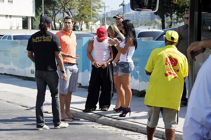 O cantor estava na frente de seu ônibus, acompanhado de suas dançarinas