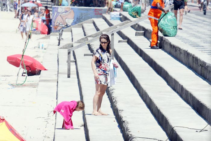 Cláudia Abreu curte praia acompanhada da família