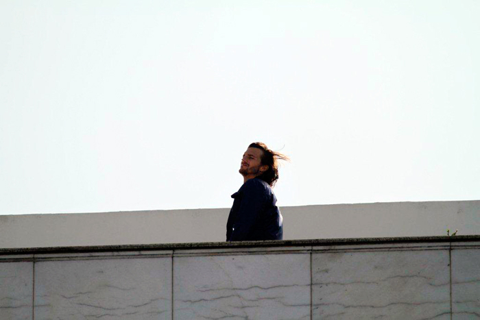 Ashton Kutcher deixou os cabelos ao vento na cobertura do hotel