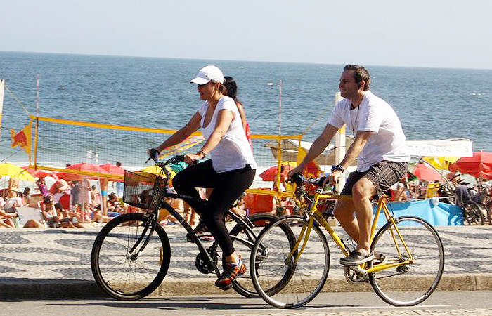 Giulia Gam pedala com amigo pela orla do Leblon