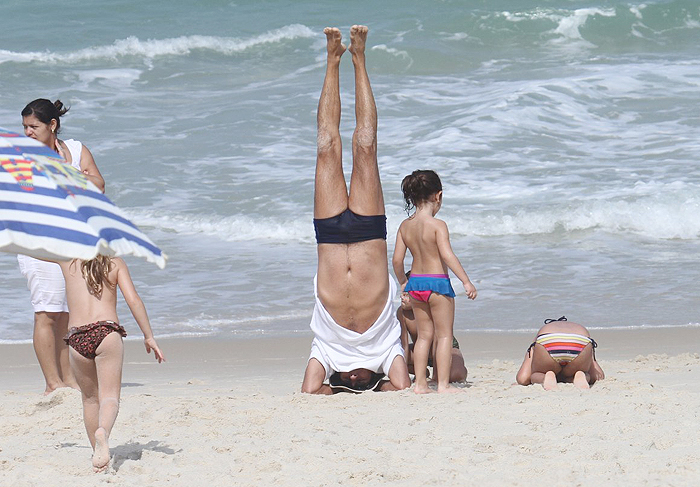Evandro Mesquita cai na brincadeira com os filhos na praia