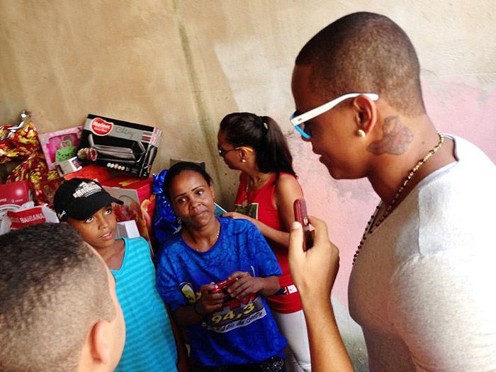 Com máscara de Papai Noel, Léo Santana distribui presentes na Bahia