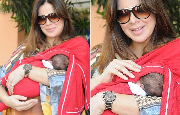 Vera Viel deixa maternidade com bebê nos braços, ao lado de Rodrigo Faro