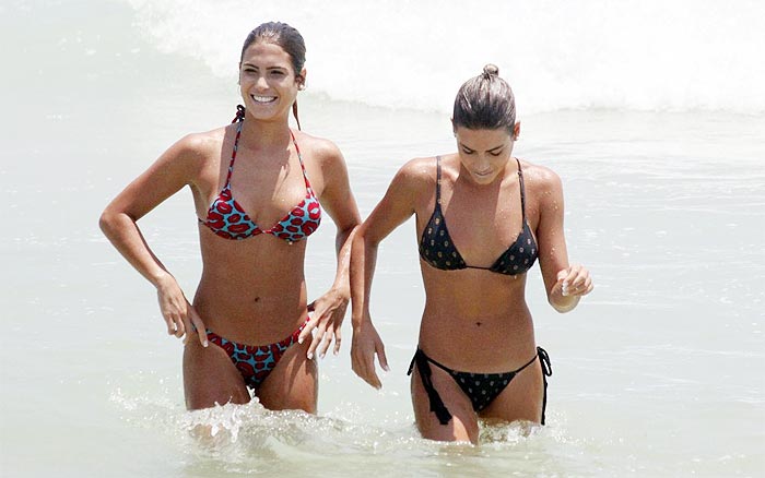 Gêmeas do nado sincronizado exibem o corpão em praia