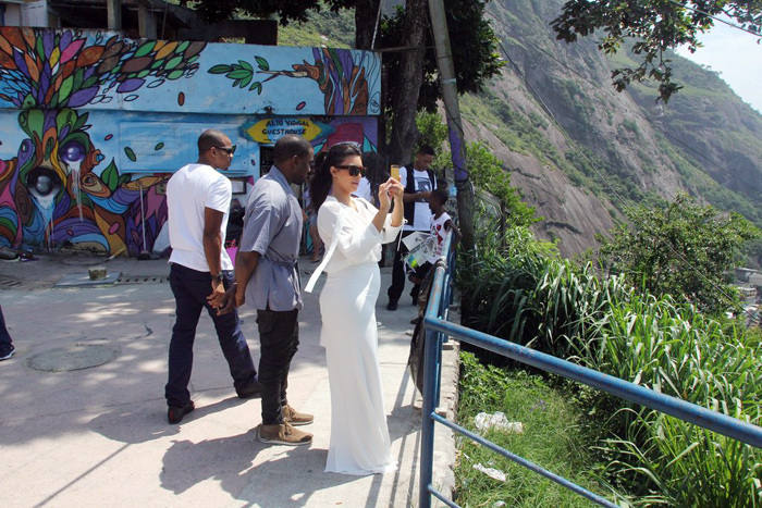 Grávida de quatro meses, Kim Kardashian exibiu a barriga saliente em um vestido branco