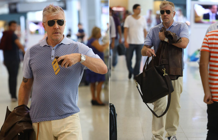 Miguel Falabella brinca de tirar foto do paparazzo no aeroporto