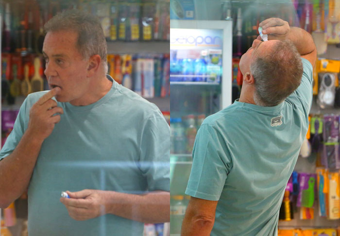 Luiz Fernando Guimarães passa pomada nos lábios em farmácia do aeroporto