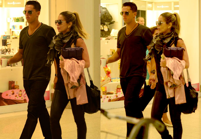 Danielle Winits e o namorado circulam de mãos dadas em aeroporto no Rio