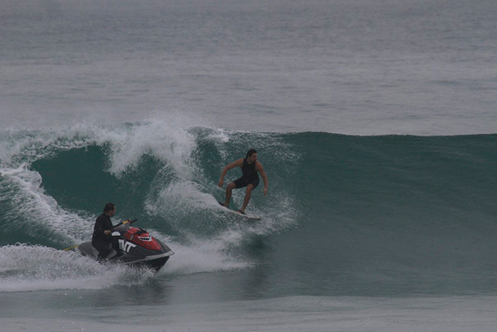 Cauã Reymond pega onda com a ajuda de um jet-ski.