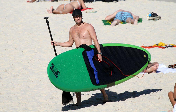 Todo equipado, Marcelo Serrado faz stand up padle em praia no Rio