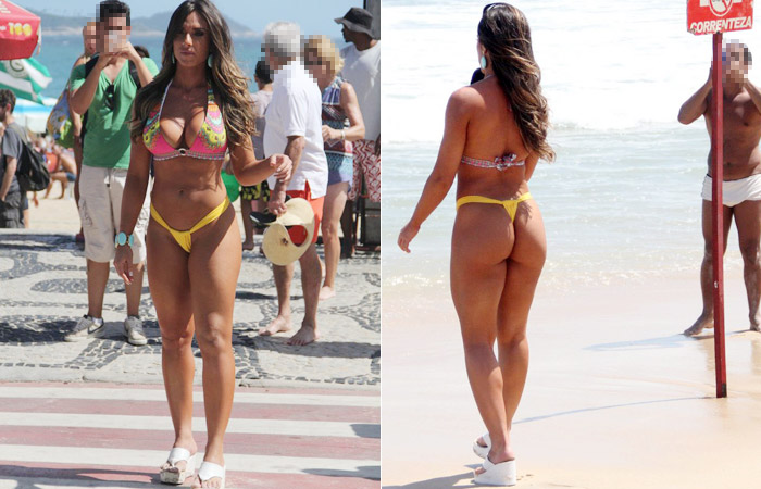 Nicole Bahls exibe o corpaço durante gravação na praia