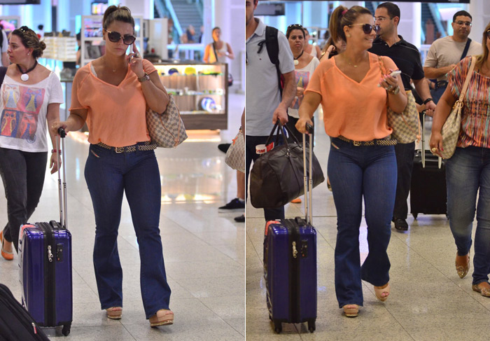 Viviane Araújo embarca sorridente no aeroporto do Rio