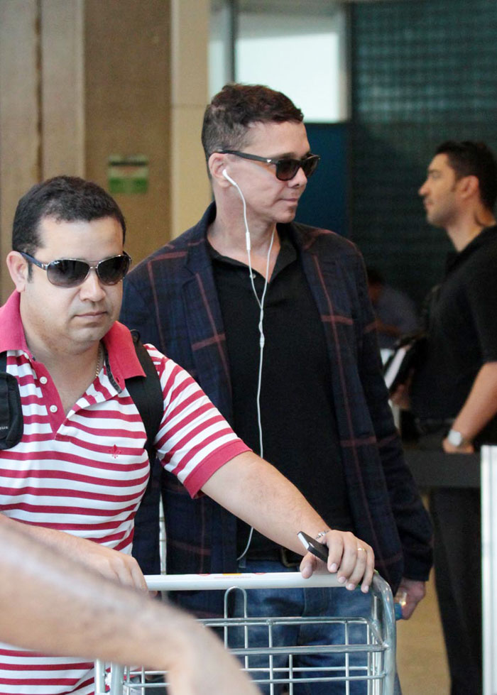 Netinho desembarca no aeroporto Santos Dumont de casaco