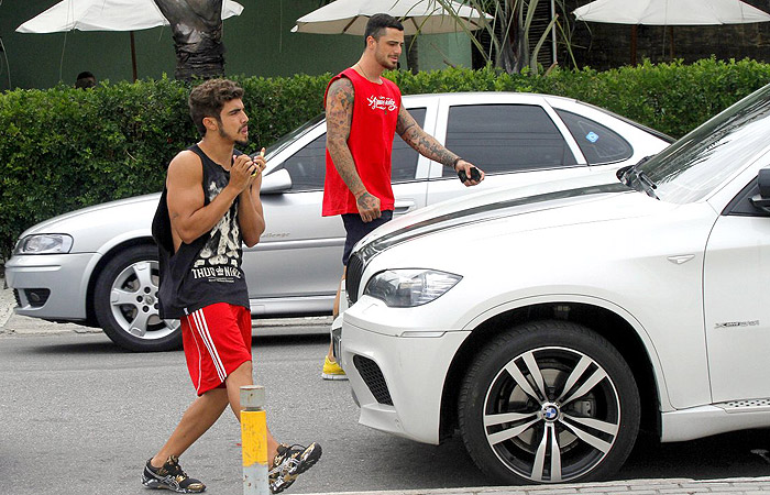 Caio Castro e Felipe Titto mostram os braços torneados em restaurante