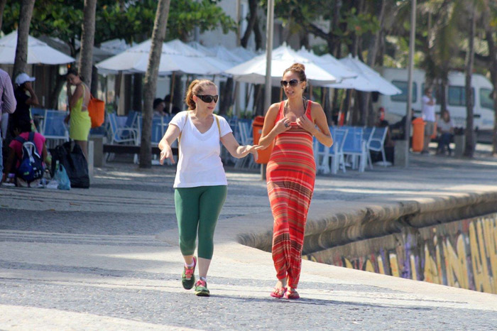 Isabela Garcia caminha pela orla de Ipanema com amiga