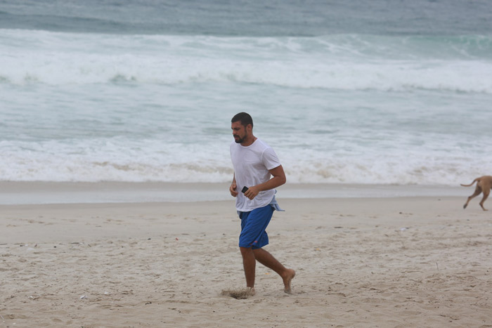 Cauã Reymond corre pela praia da Barra da Tijuca