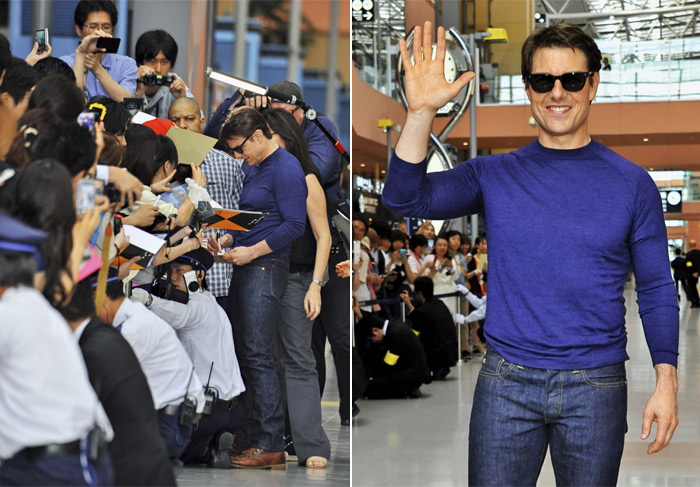 Sorridente, Tom Cruise atende a fãs em aeroporto no Japão