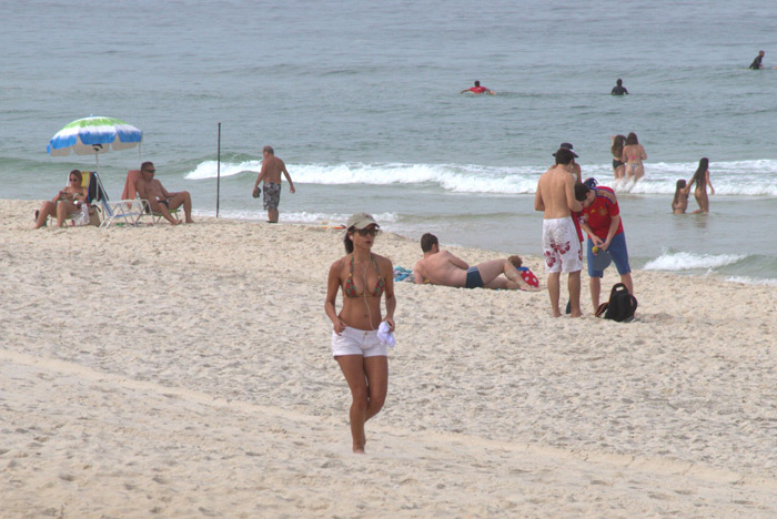Anna Lima acena para paparazzo em dia de exercícios na praia da Barra