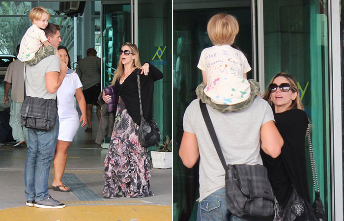 Danielle Winits paparica namorado e filho antes de embarcar no Rio de Janeiro