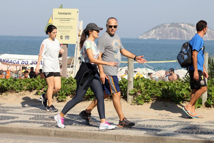 Patrícia Poeta caminha pela orla de Ipanema com o marido