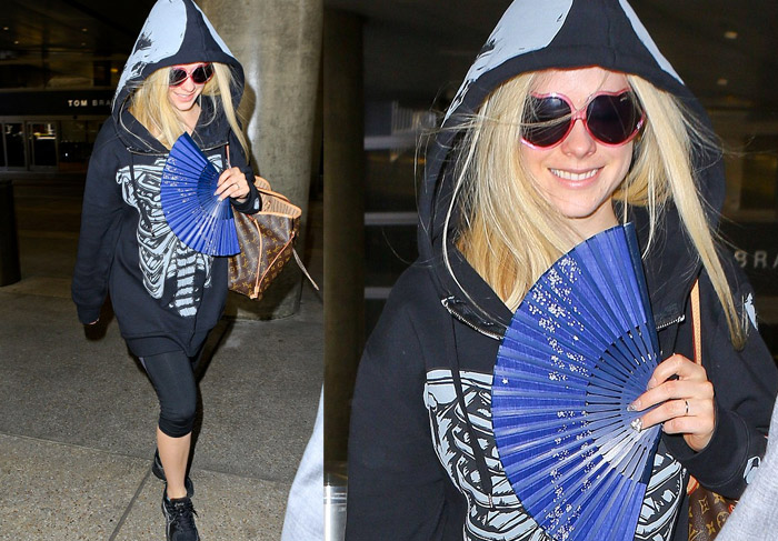 Avril Lavigne embarca vestida de caveira, no aeroporto de Los Angeles