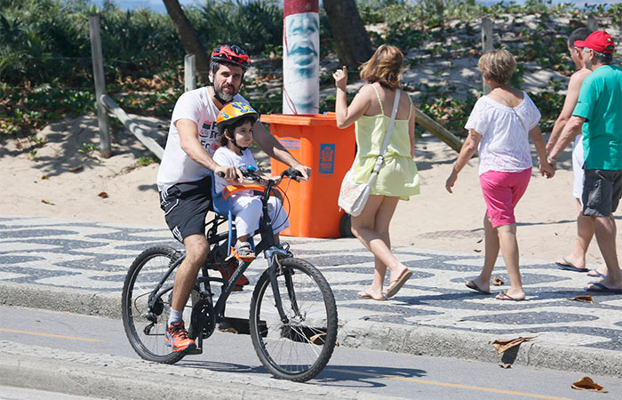 Eriberto Leão passeia de bike com o filho pela orla de Ipanema