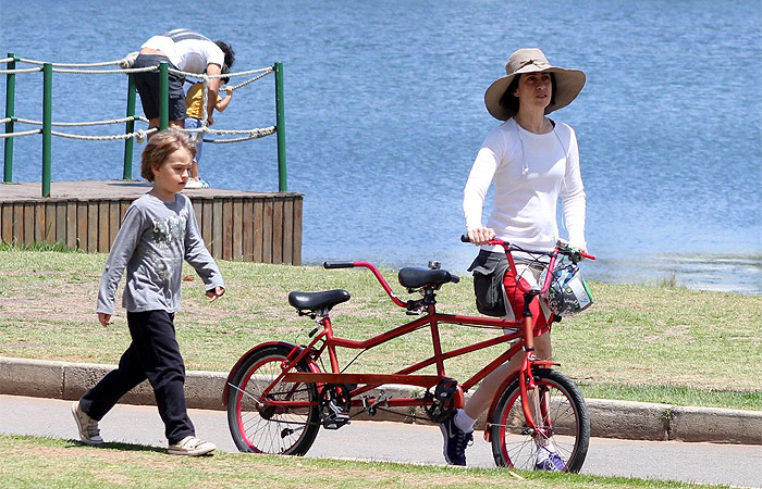 Fernanda Torres usa chapelão para andar de bike com o filho