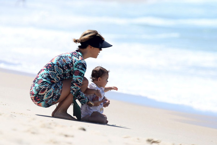 Guilhermina Guinle paparica a filha Mina em praia carioca