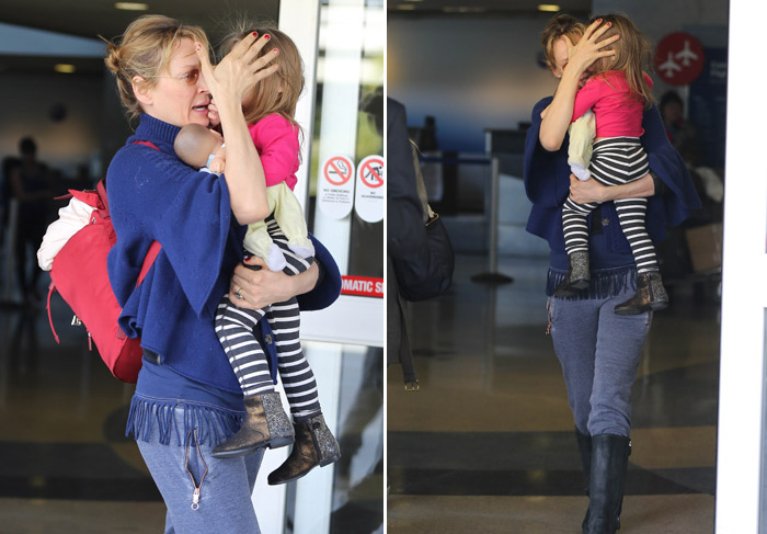 Uma Thurman tenta esconder o rosto da filha em aeroporto