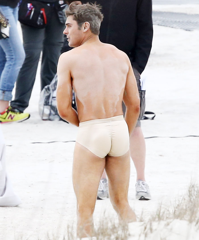 Zac Efron aparece ‘quase’ nu em filmagem na praia