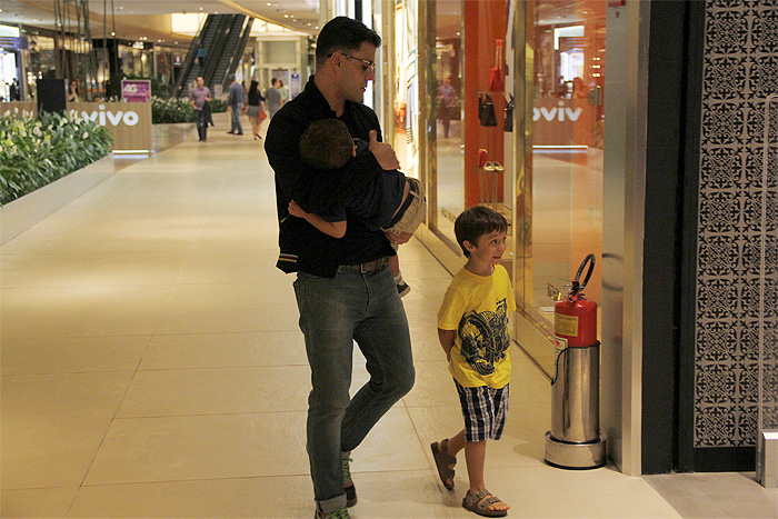 Juliano Cazarré passeia com a família em shopping