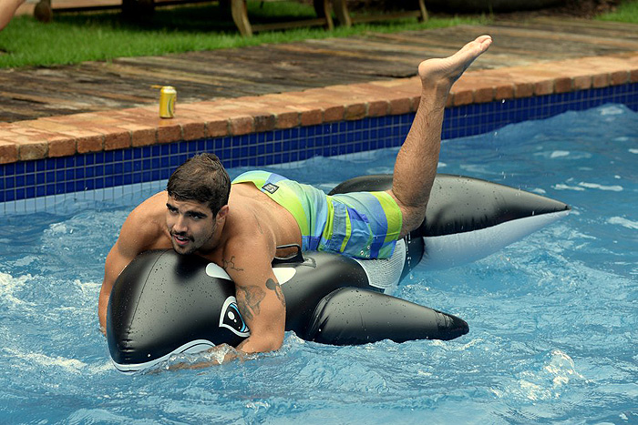 Depois de muitas brincadeiras com a bóia, Caio decidiu parar para se refrescar um pouco, e ficou apenas com os pés dentro da água