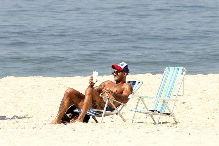 De sunga azul, Lucas Lucco mostra os músculos em praia do RJ