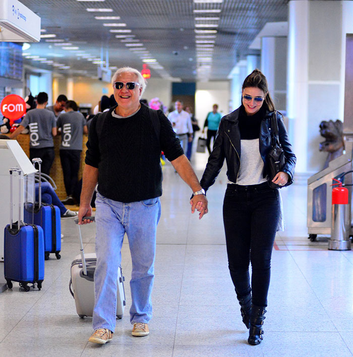  Antônio Fagundes esbanja sorrisos com namorada em aeroporto