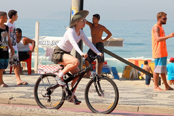  Fernanda Torres encara sol para pedalar na orla de Ipanema