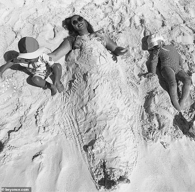 Beyoncé brinca de ser enterrada na areia com as filhas gêmeas