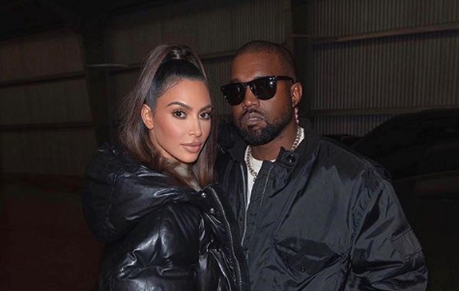Kin Kardashian e Kanye West de jaqueta preta
