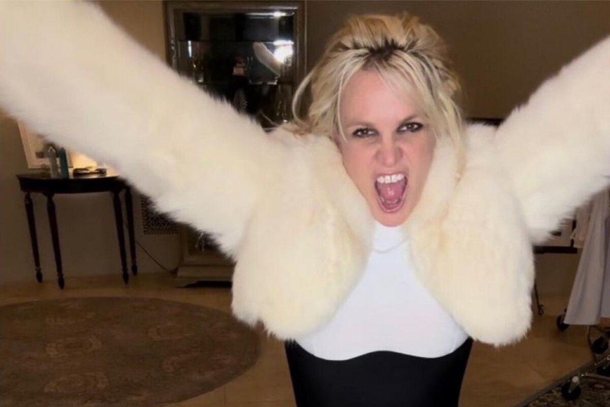 Britney Spears de braços abertos, casaco de pele