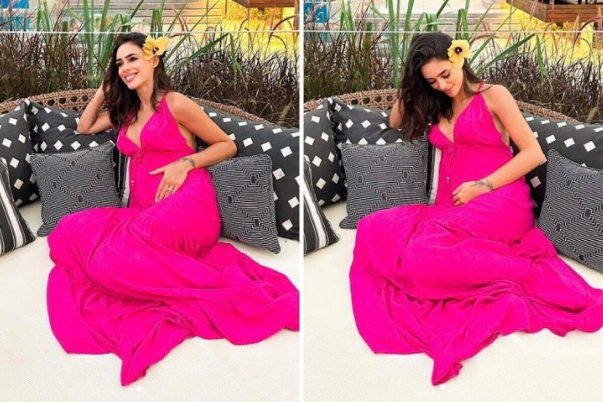 Bruna Biancardi sentada, de vestido cor de rosa, com a mão na barriga