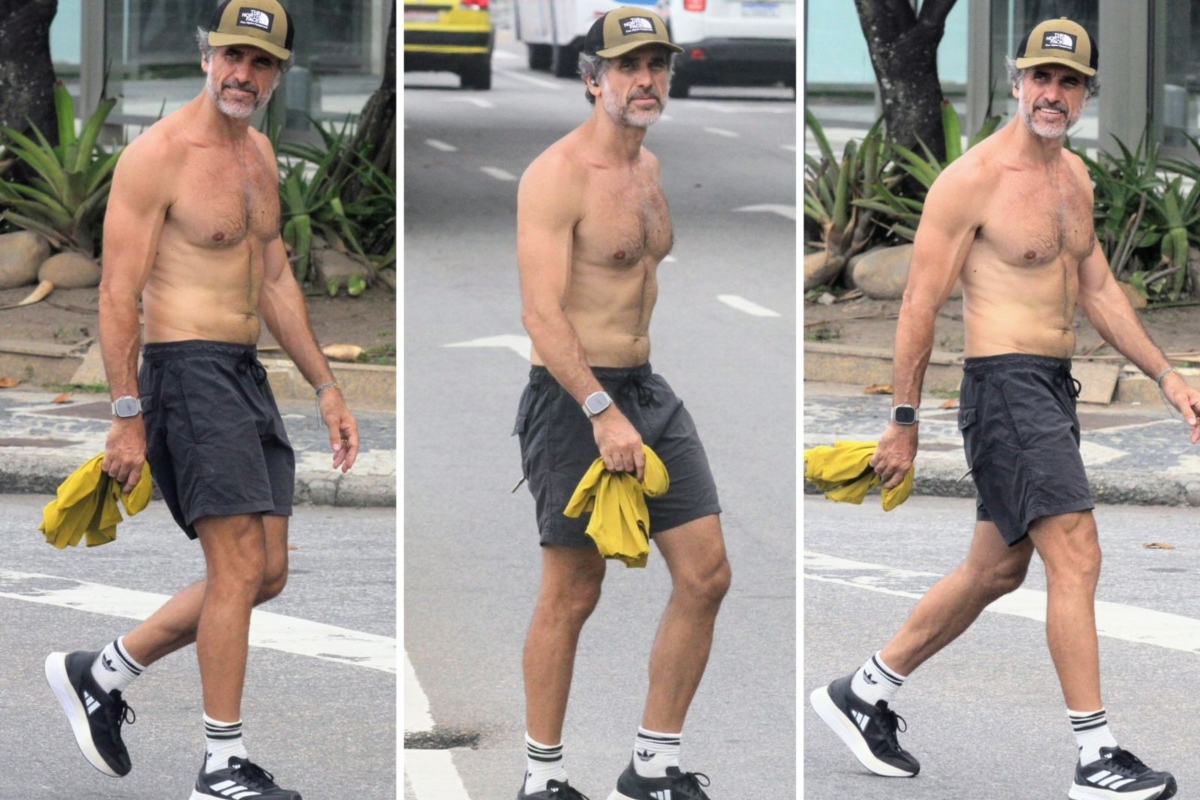 Eriberto Leão caminhando sem camisa, de boné, tênis e bermuda preta