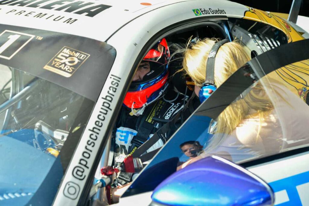 Ana Hickmann falando com Edu Guedes dentro de carro na Porsche Cup Brasil