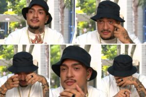 MC Bin de chapéu preto e camisa branca