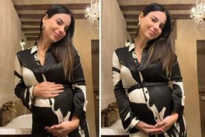 Sthefany Brito de vestido, com as mãos na barriga