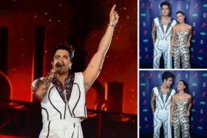 Luan Santana de roupa branca com detalhes preto, cantando e com Jade Magalhães